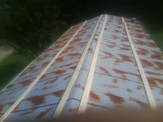 Rusted metal roof panels with new wood purlins before replacement — Storm Damage Roof Repair in Oldsmar by Roofing Brothers